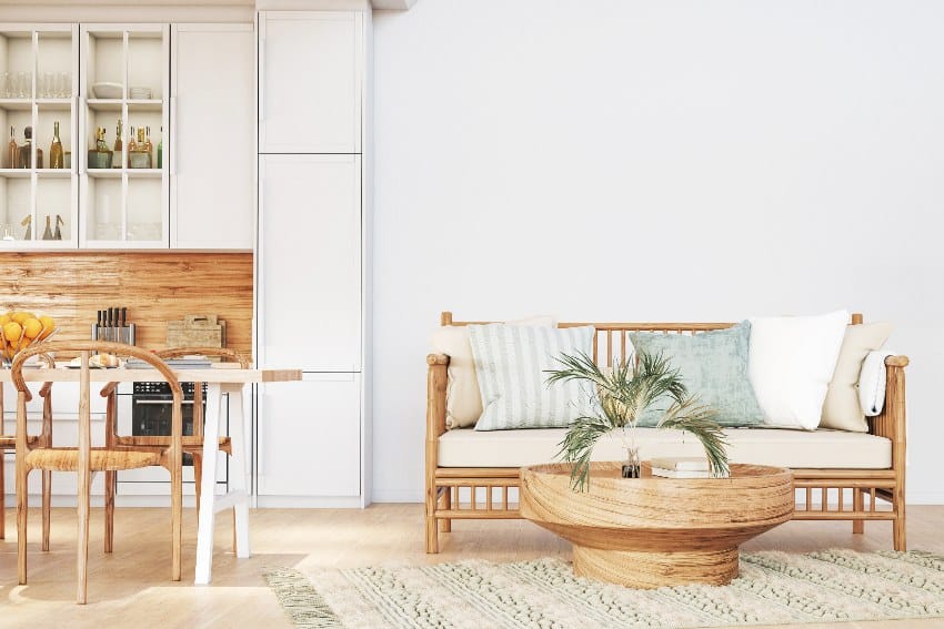 Home interior showing room and kitchen with health-conscious furniture and white wall