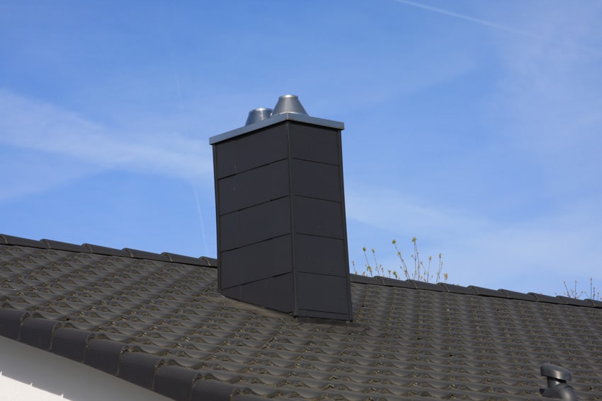 House exterior with black roof and DIY faux chimney
