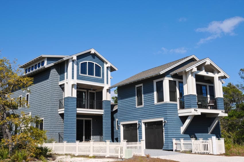 House exterior with coastal blue exterior paint colors, siding, windows, garage doors, and pitched roof
