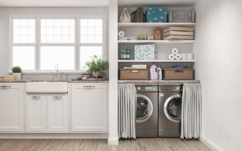 Kitchen with laundry space, washing machine, dryer, curtain, sink, cabinets, window, and wood floor