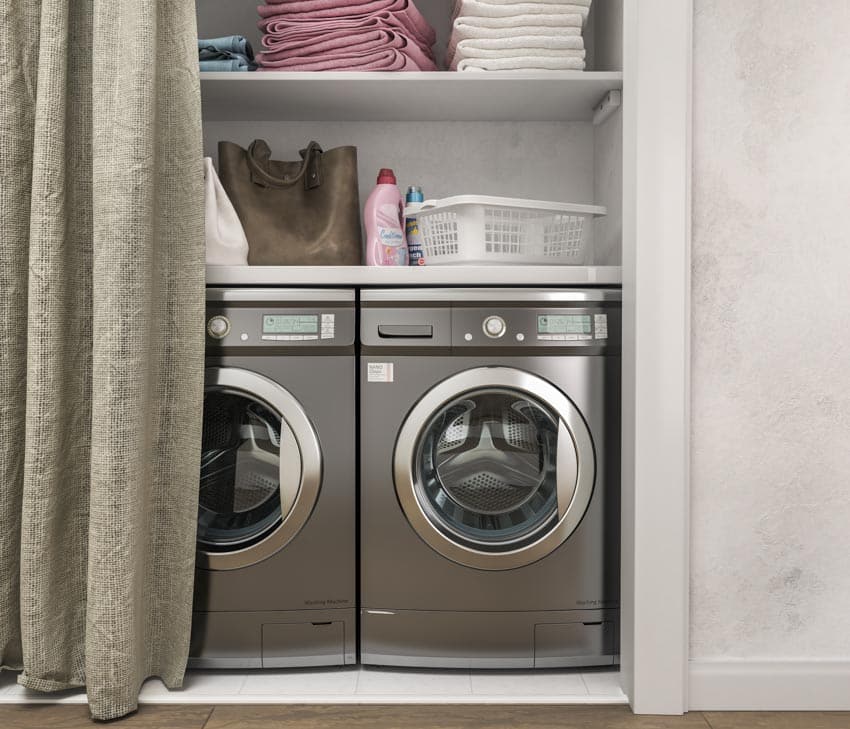 Dryer and washer with white laundry tray and stacked folded towels
