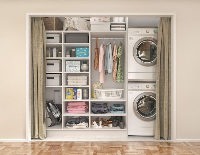 Laundry room with washing machine, dryer, shelves, wood flooring, and curtain
