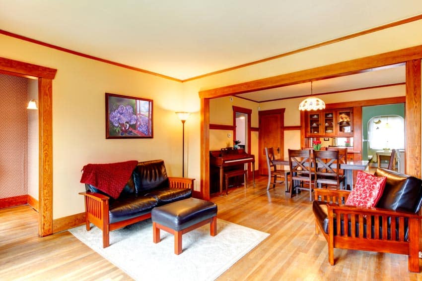 Room with wood-framed doorways, sofa and ottoman