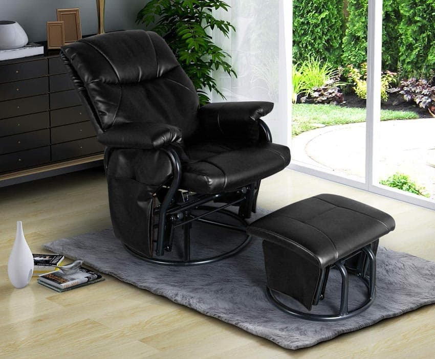 Living room with black leather glider chair, ottoman, rug, and glass door