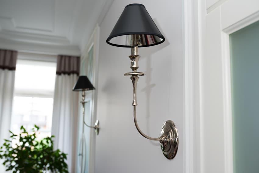 Luxury wall sconces installed on a white bedroom wall