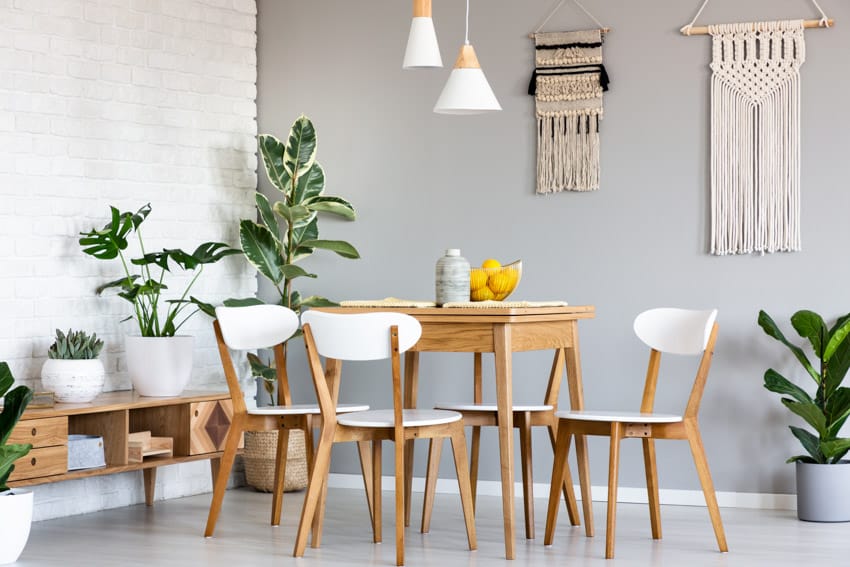 Minimalist dining room with MDF furniture, table, chairs, indoor plants, console table, and white brick accent wall
