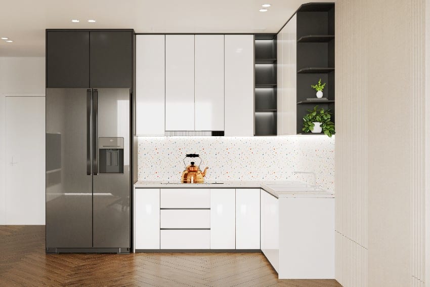 Minimalist kitchen interior features white cabinet with polyurethane finish and gray shelf refrigerator beside it