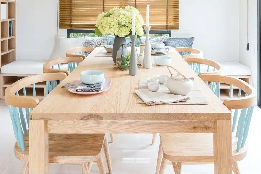 Modern dining room with ash wood dining table set and vase of plants