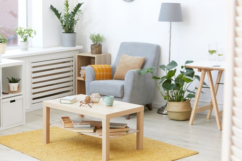 Modern domestic room with light color furniture including armchair and coffee table in the house