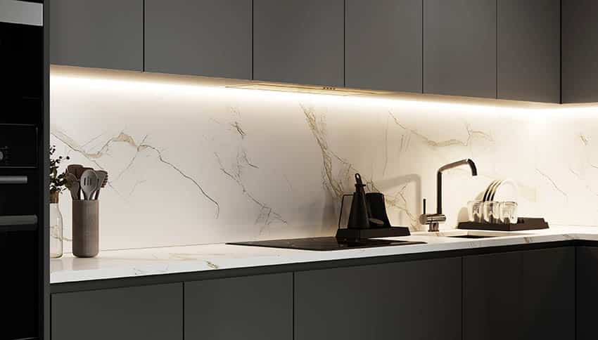 Modern kitchen with black cabinets over sink calacatta gold look porcelain slab backsplash