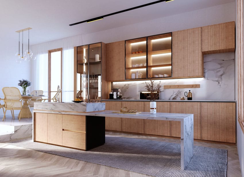 Modern kitchen with island, countertop, marble backsplash, ceiling lights, and cabinets