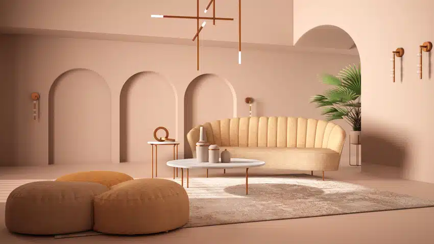 Modern living room with pastel colored walls, large pillow pouf, couch, coffee table, and pendant lights