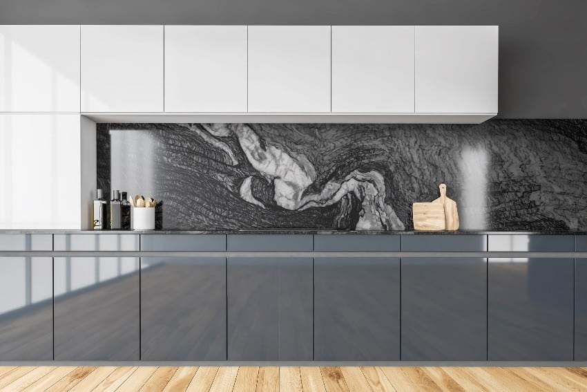 Modern minimalist black and white kitchen with polyurethane kitchen cabinets, marble backsplash, appliances, stove and parquet floor