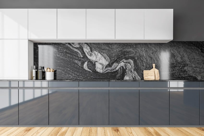 Modern minimalist black and white kitchen with glossy cabinets, marble backsplash and parquet floor