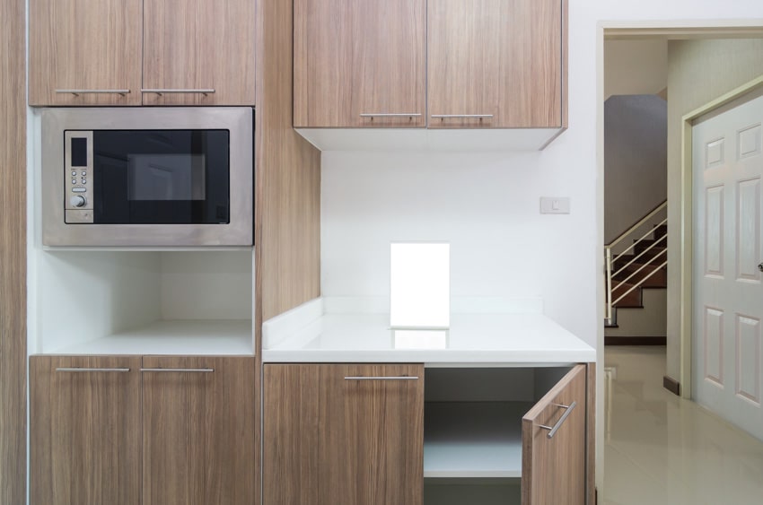 Newly constructed kitchen with pressed wood cabinets and oven