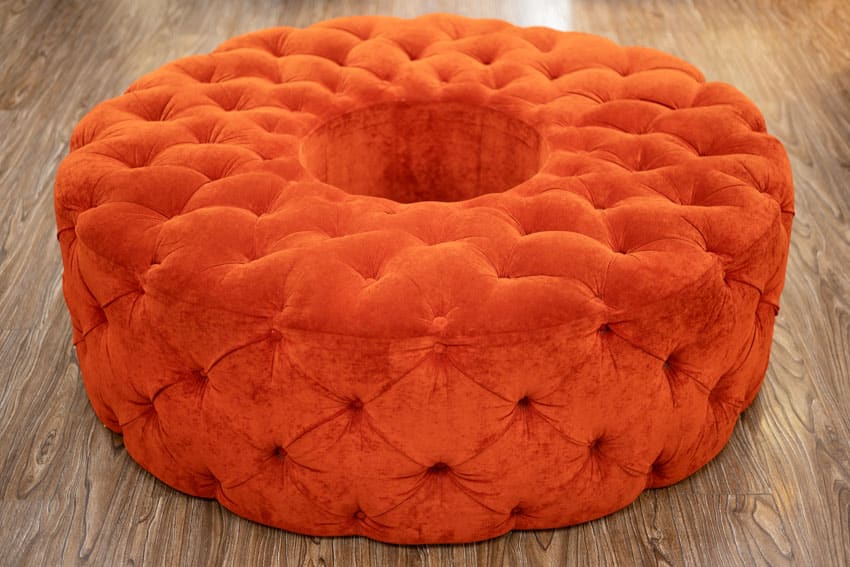 Orange pouf couch on wood flooring for home interiors