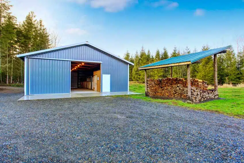 Pole barn with modern color schemes, pitched roof, and wood log shed
