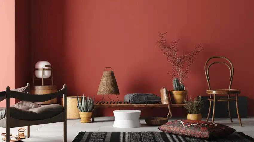 Red living space with chairs, rug and different decor pieces