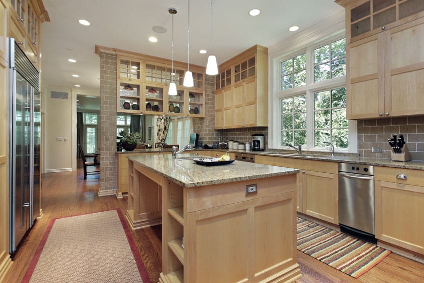 Rustic kitchen with mission style cabinets, island, pendant lights, countertops, dishwasher, tile backsplash, and window