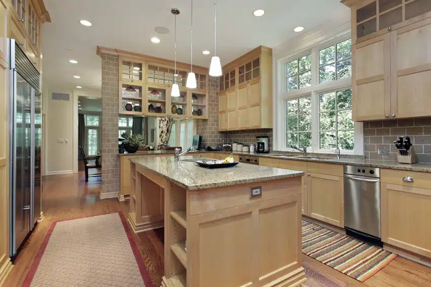 Kitchen with granite counterop island, pendant lights, dishwasher and window