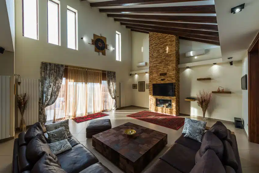 Rustic room with high ceiling and sectional sofa