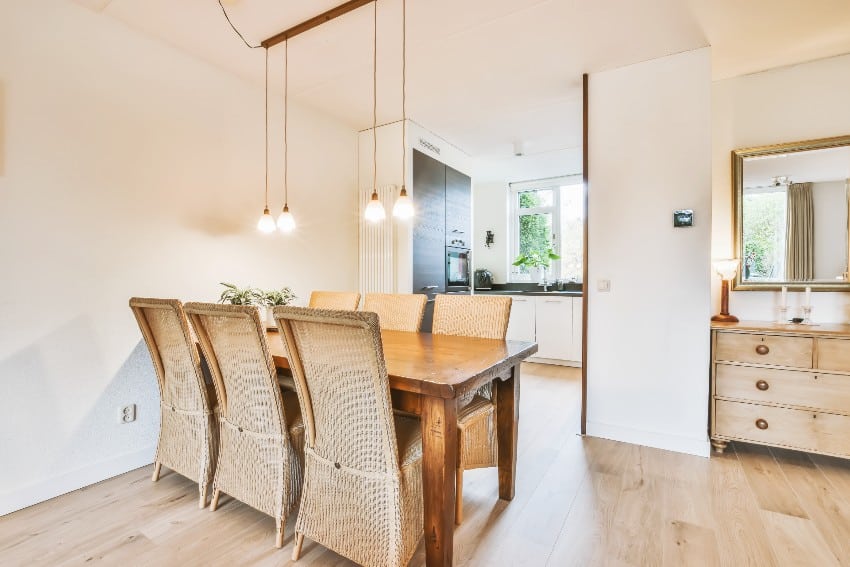 Dining area with pendant lights, console table and light wood floors