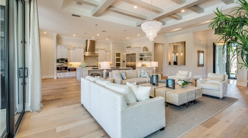 Open concept with covered ceiling, white sofa set, cream walls and sliding doors