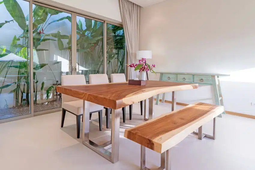Table with bookmatch wood grain for dining rooms with bench seating and glass door