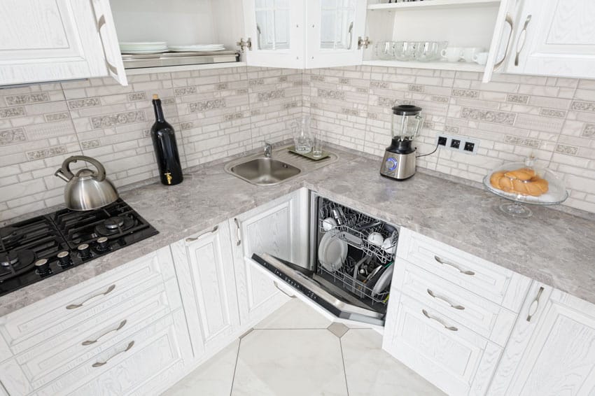 Traditional kitchen with sueded super white granite countertop, white cabinets, stove, and dishwasher