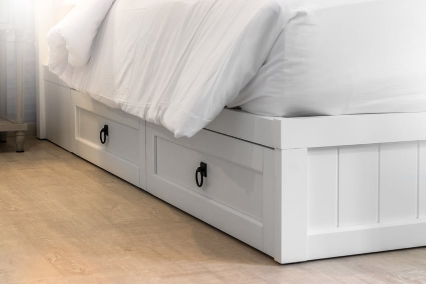 White bedframe with mattress and drawers
