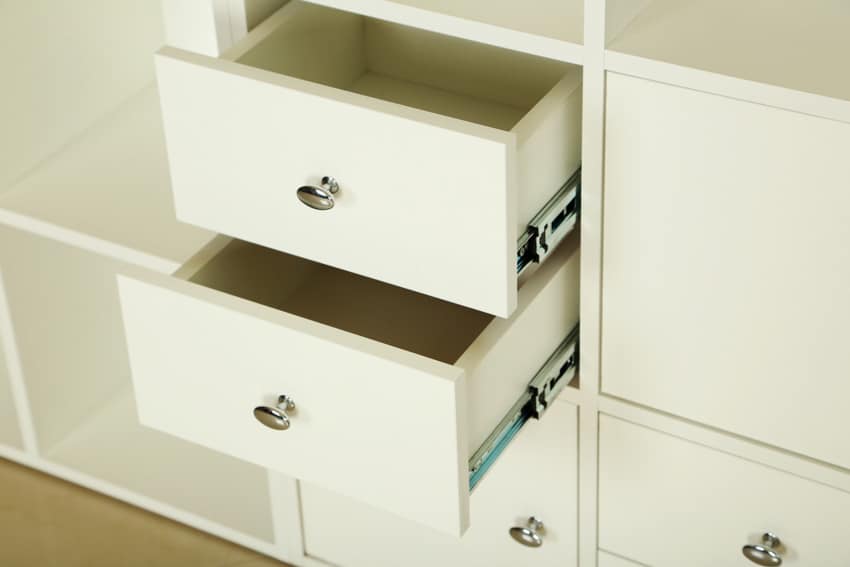 White cabinet with hardware drawers and slides