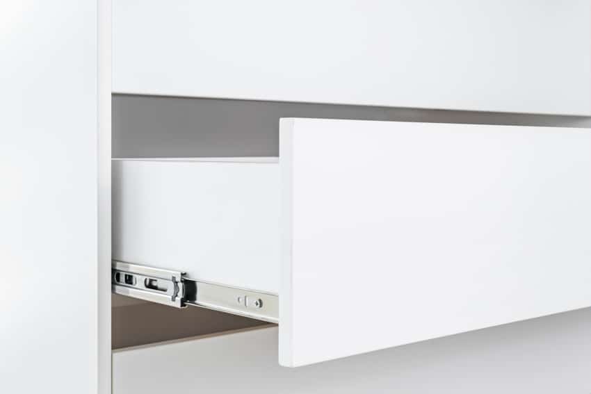White cabinet with side mounted slide
