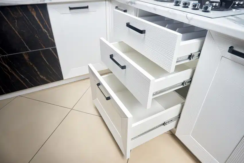 White kitchen with open drawers