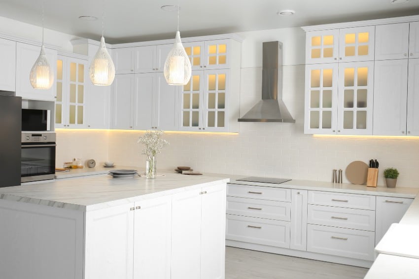 Beautiful white kitchen interior with pendant lights and formica countertops