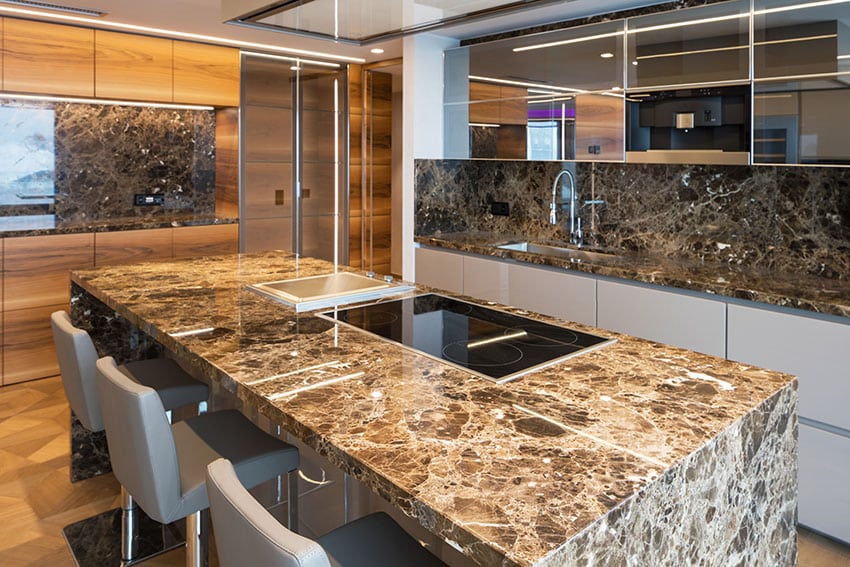 Elegant kitchen with onyx countertops island backsplash upholstered chairs induction stove on kitchen island