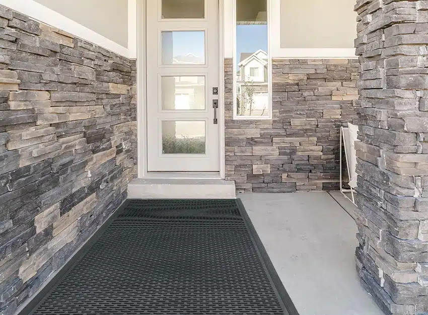 Entryway with long slip mat stone wall cladding