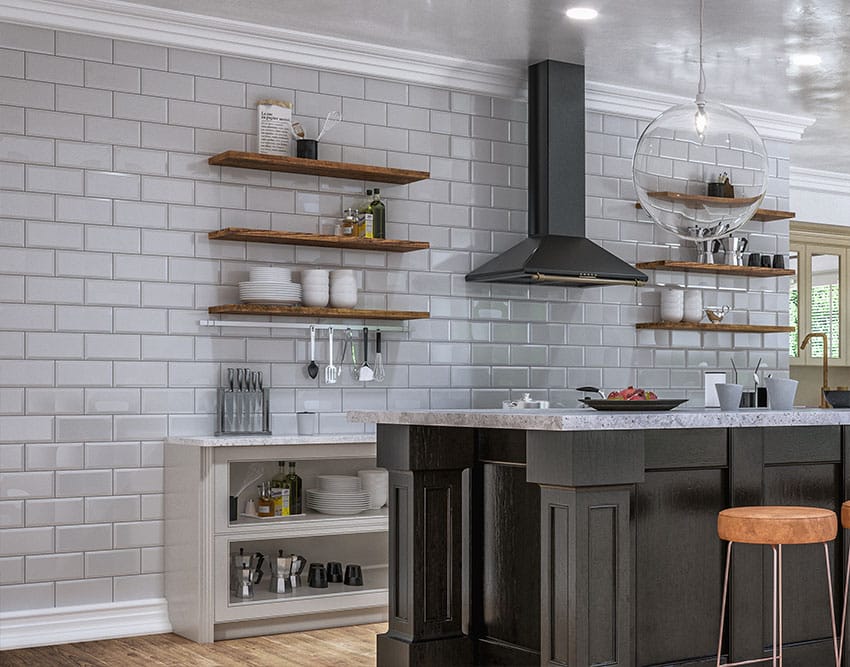 Kitchen with gray subway tile wall floating shelves range hood marble countertop