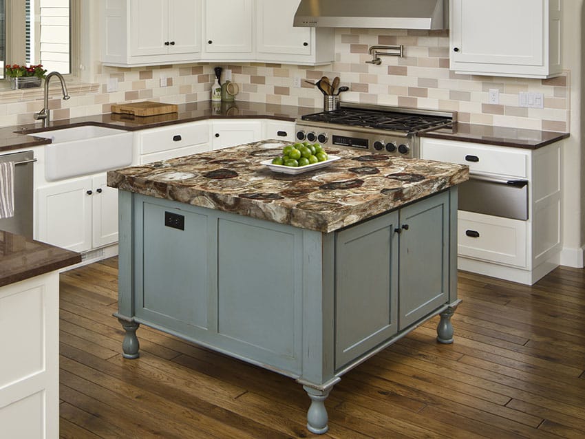 Kitchen with small teal kitchen island with petrified wood countertop 