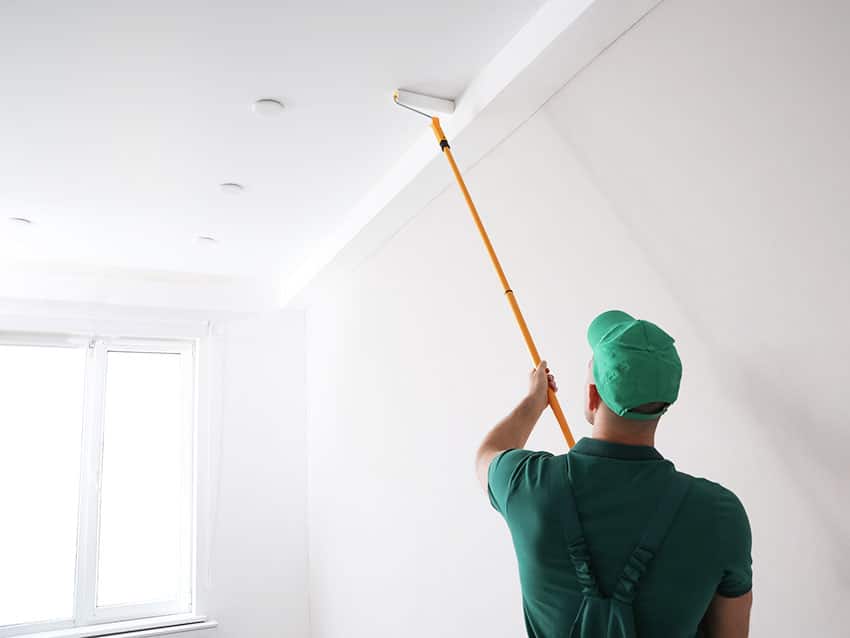 Painting ceiling with paint roller