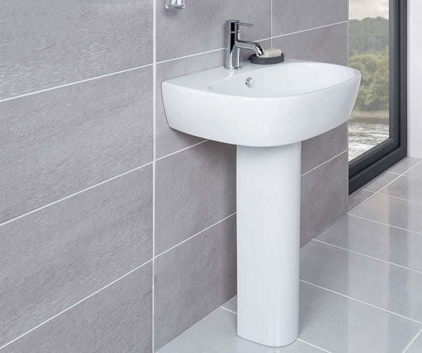 Pedestal sink bathroom with large tiles