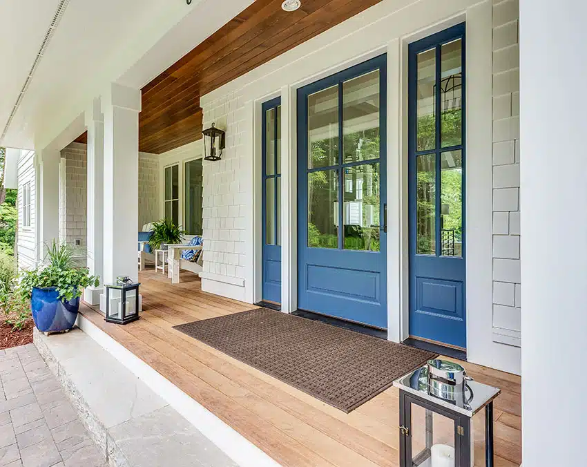 Porch with blue French front door wood floor subway wall large door mat