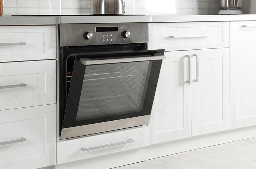Stove built-in oven on white cabinets