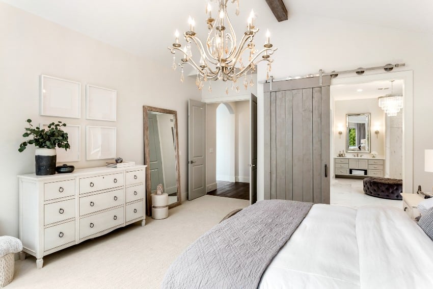 Bedroom with sliding barn door, and white chest of drawers