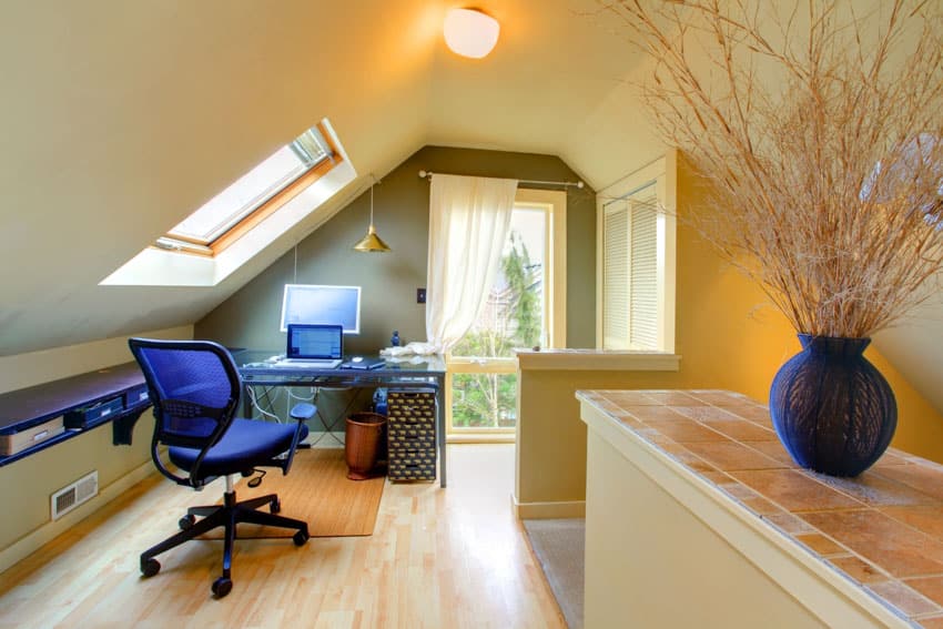 Attic office with desk, chair, sloping ceiling, skylight window, ceiling light, curtain, and wood flooring
