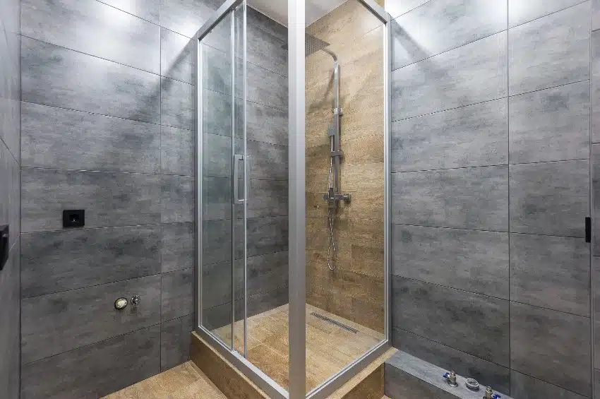 Bathroom shower with glass doors and slate walls