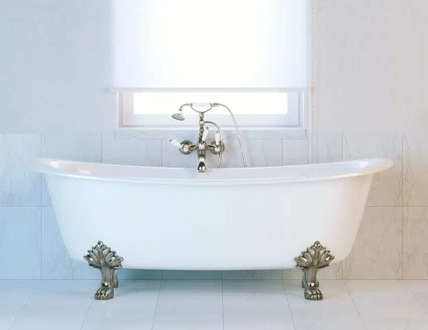 Bathroom with freestanding clawfoot tub and clawfoot bathtub faucet