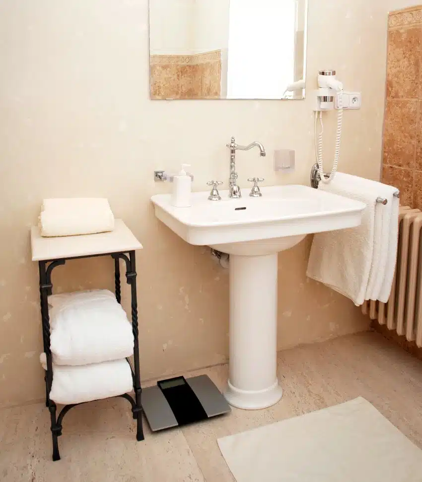 Bathroom with large pedestal sink and mirror 