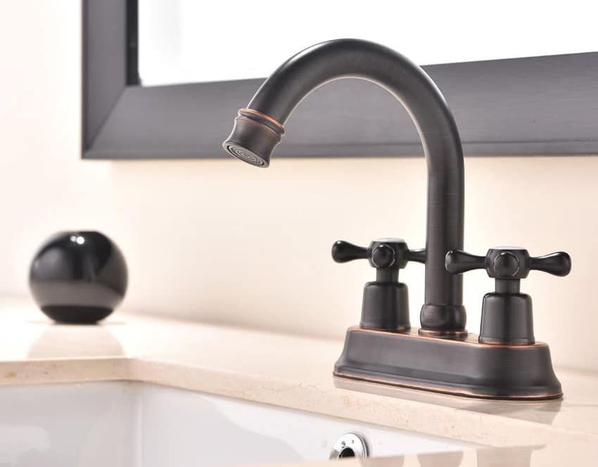 Bathroom with oil rubbed bronze faucet, sink, and mirror