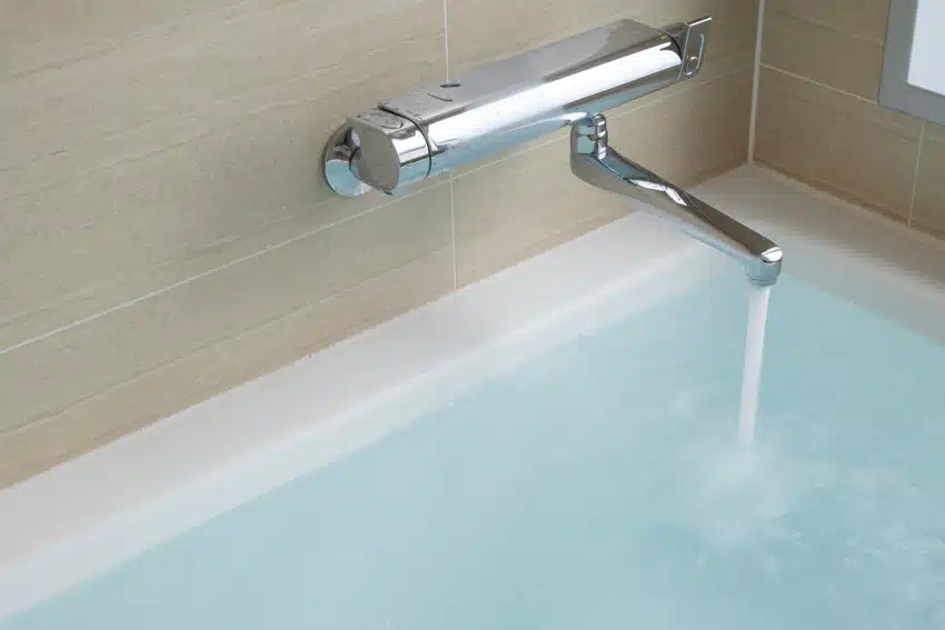 Bathroom with tub and stainless steel wall mount bathtub faucet