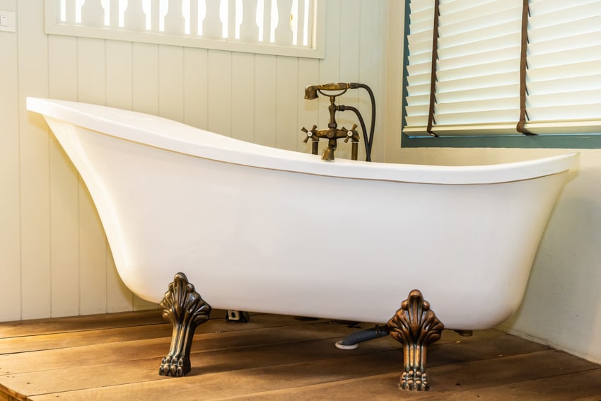 Bathroom with tub, faucet, wood flooring, window, blinds, and lion paw clawfoot tub feet